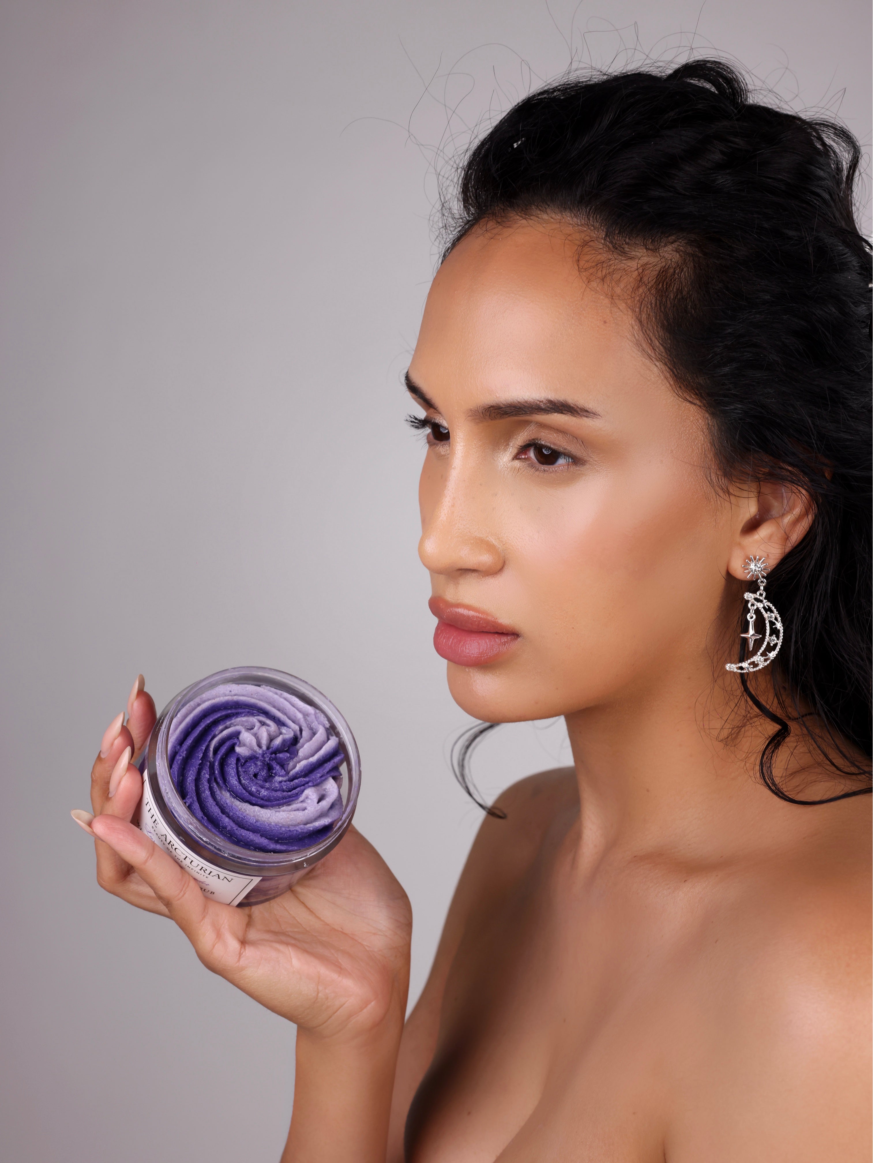 Woman holding The Arcturian Lavender Whipped Scrub against a neutral background