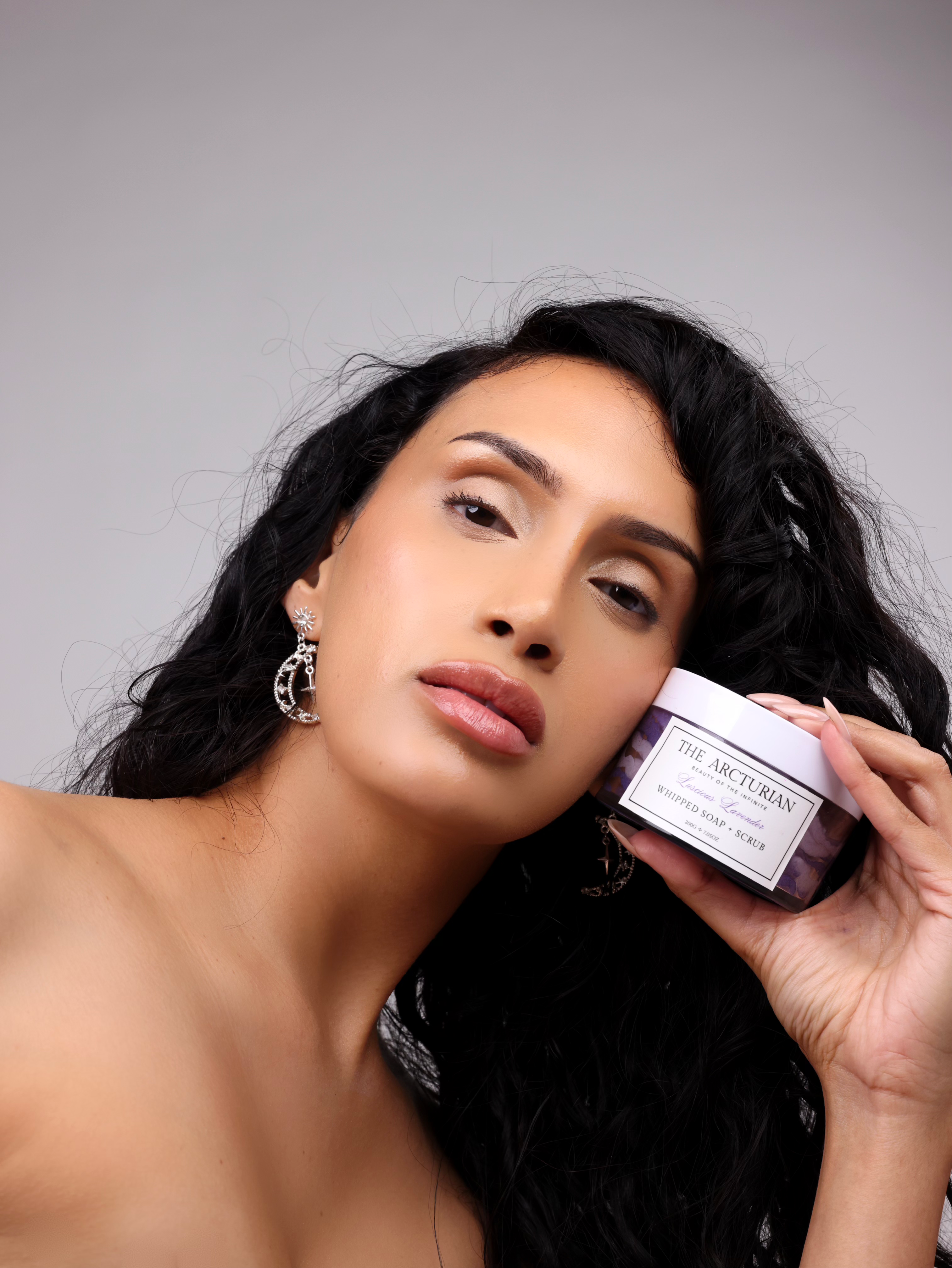 woman posing confidently with The Arcturian Lavender Whipped Scrub
