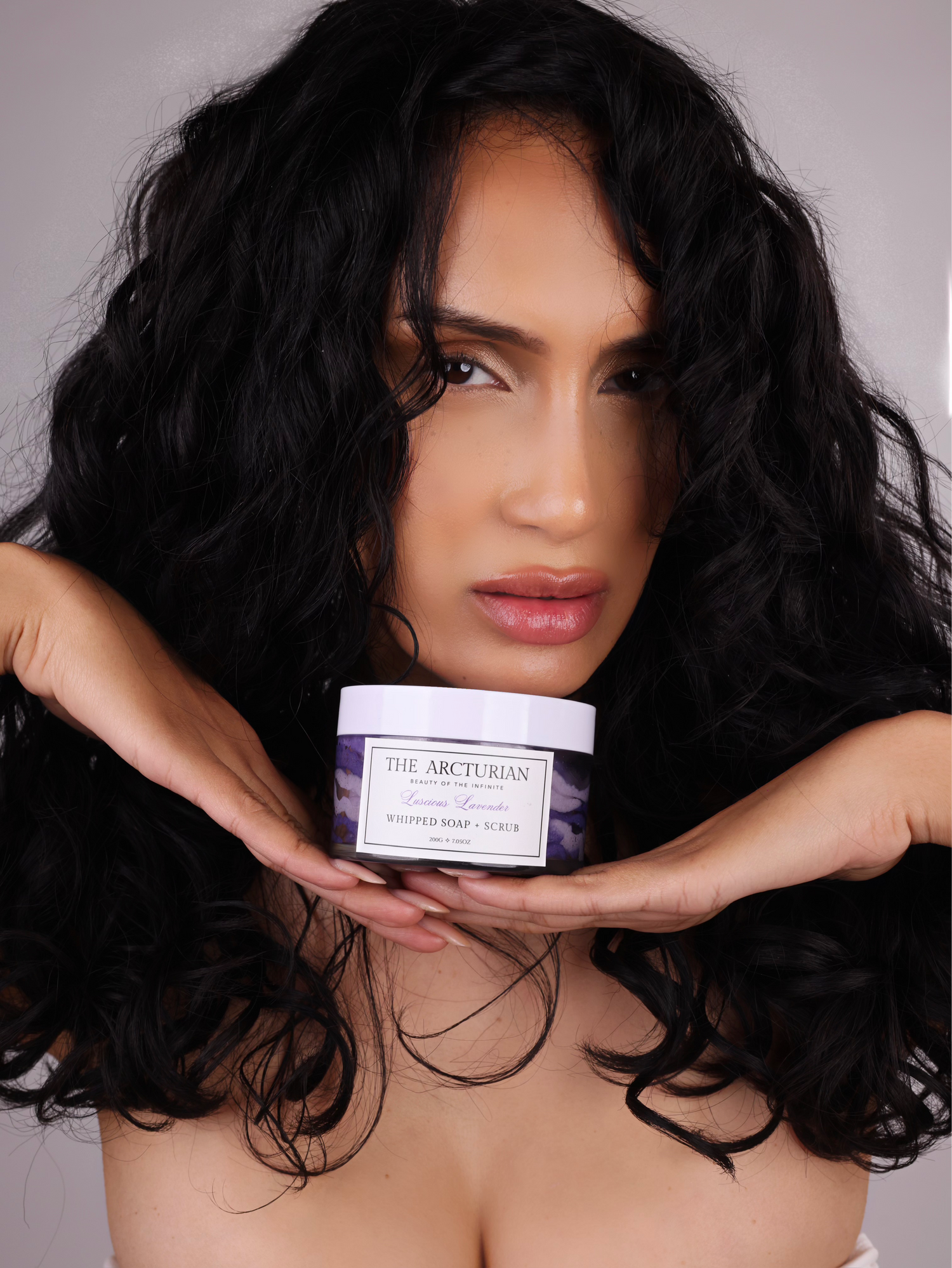 model holding The Arcturian Lavender Whipped Scrub