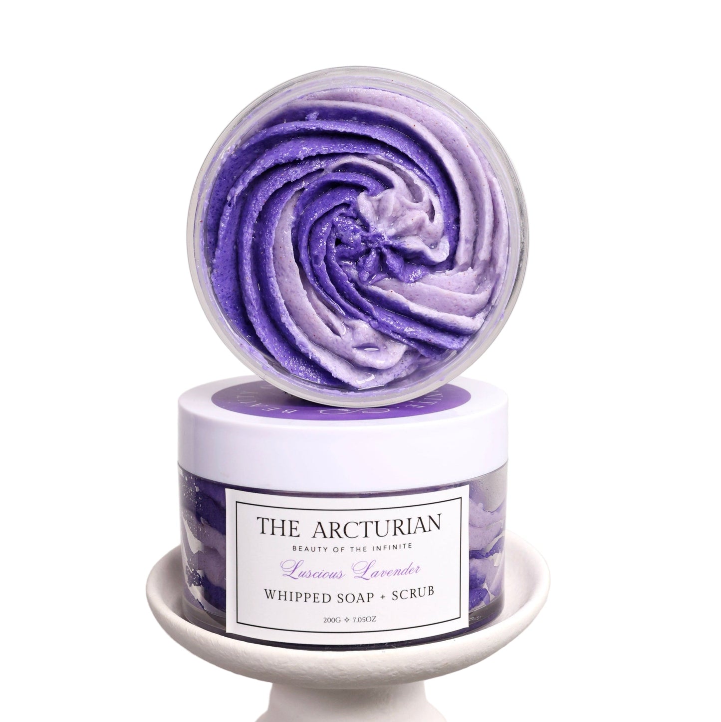 Purple and white whipped soap scrub with 'The Arcturian' branding on a white background