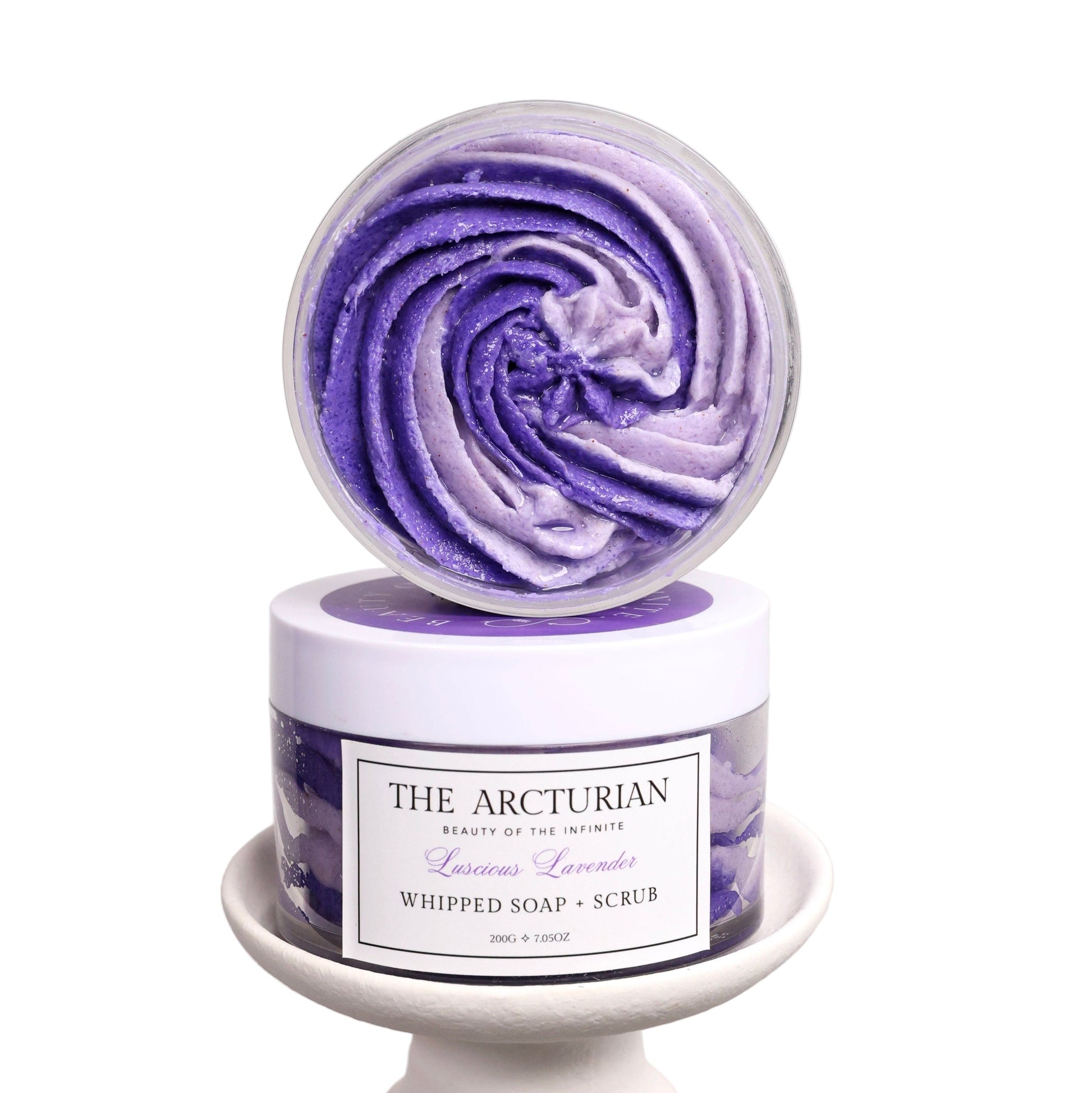 Purple and white whipped soap scrub with 'The Arcturian' branding on a white background