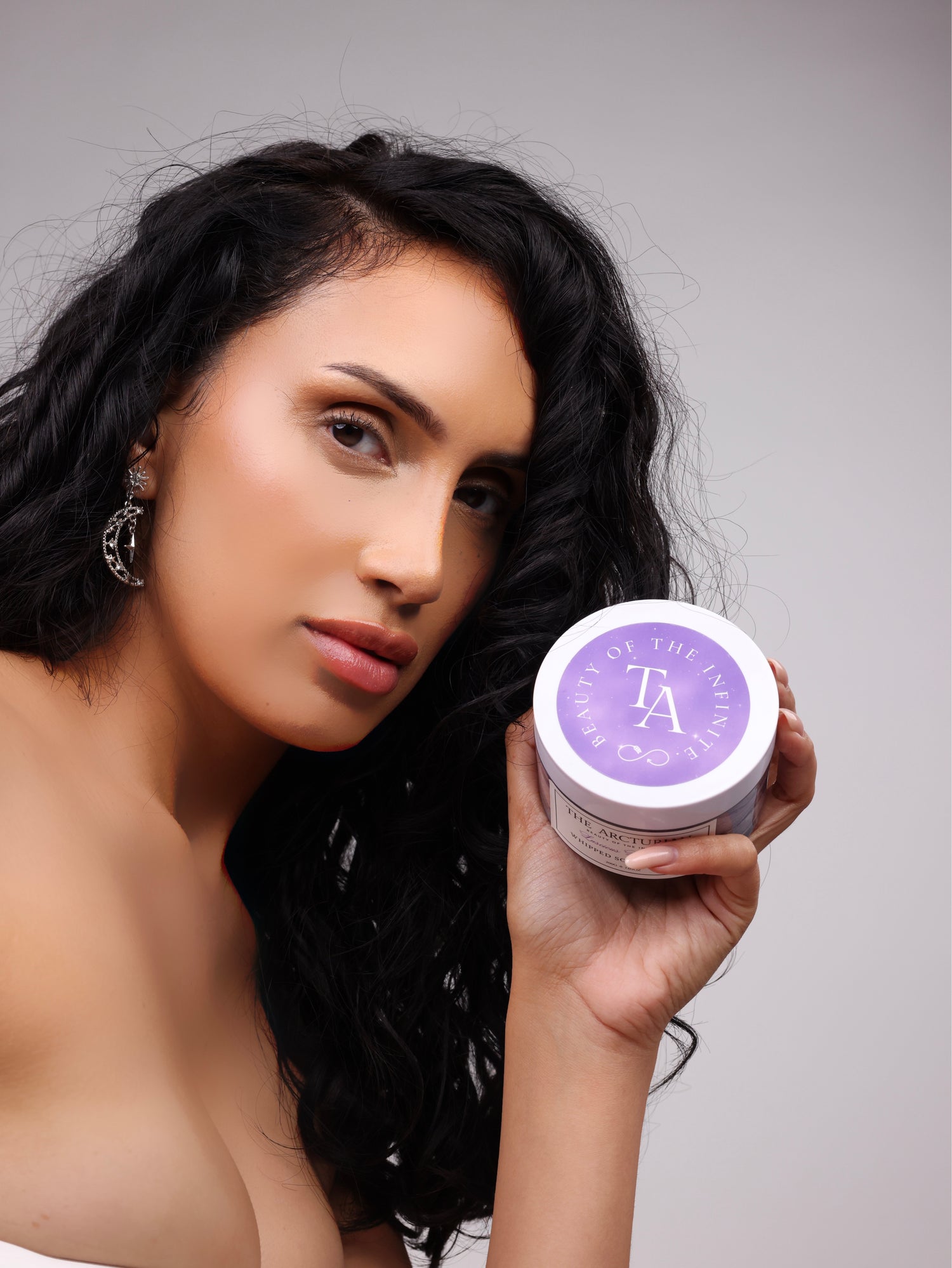 model holding The Arcturian Lavender Whipped Scrub while looking at camera