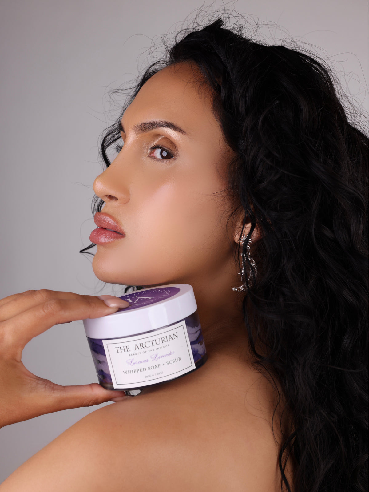 model holding The Arcturian Lavender Whipped Scrub 