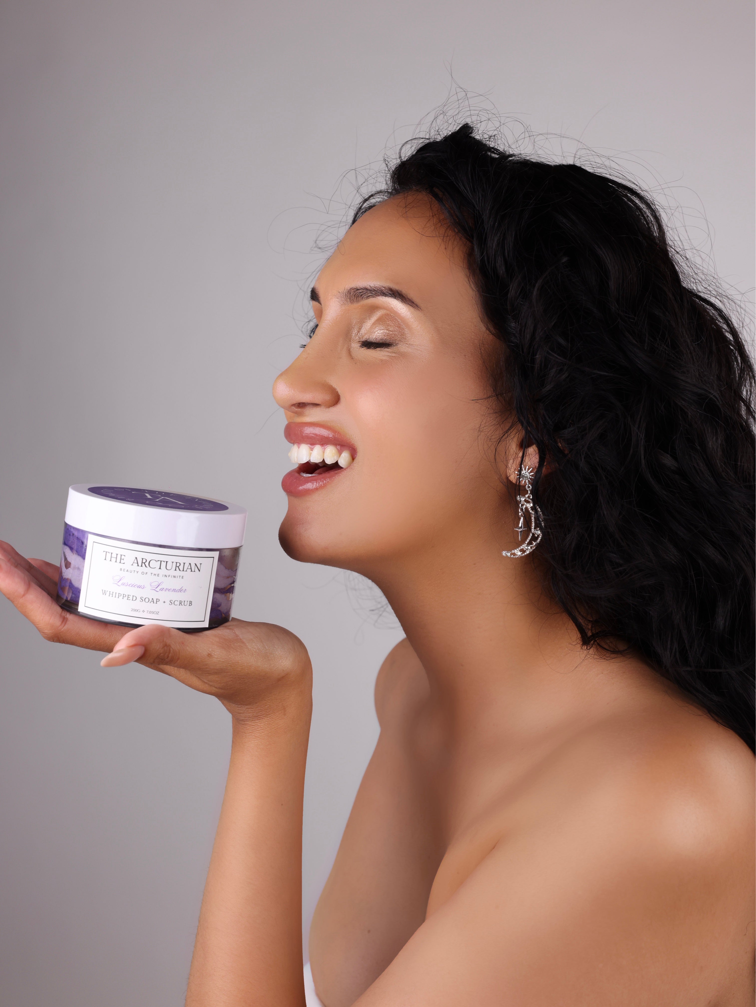 woman holding The Arcturian Lavender Whipped Scrub and smiling / laughing 